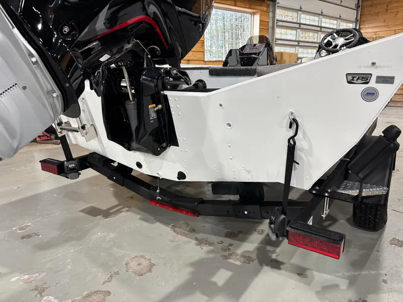 Slide: The Image of 2025 Lund 1975 Renegade SS boat on trailer in garage setting. - 21