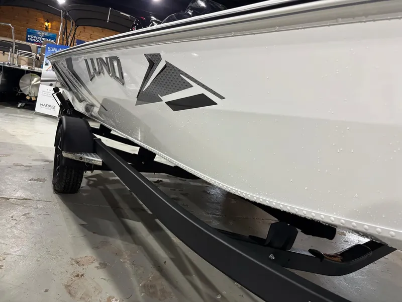 Slide: The Image of 2025 Lund 1975 Renegade SS boat on trailer in showroom. - 24
