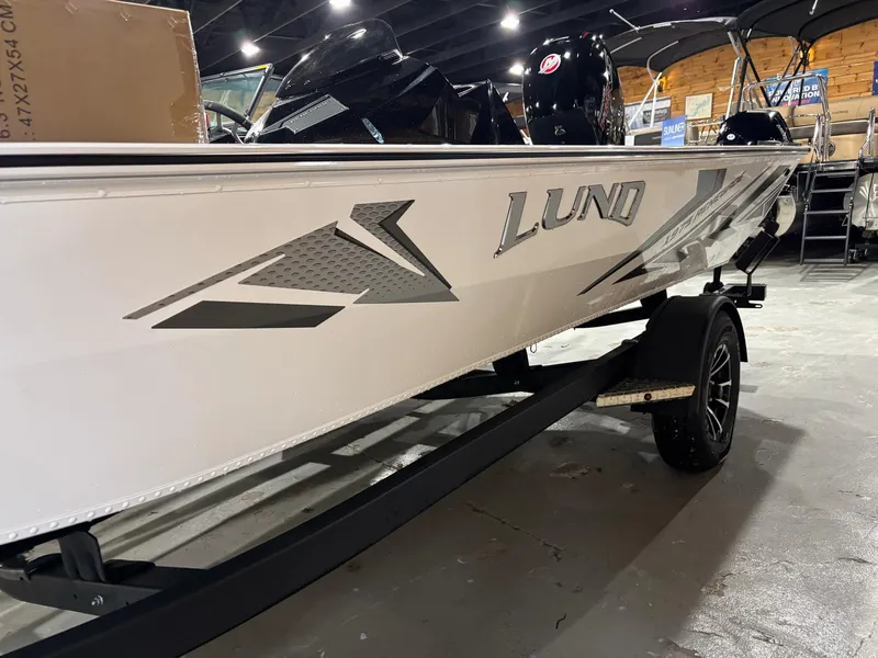 Slide: The Image of Lund 1975 Renegade SS 2025 model boat on trailer in showroom. - 4