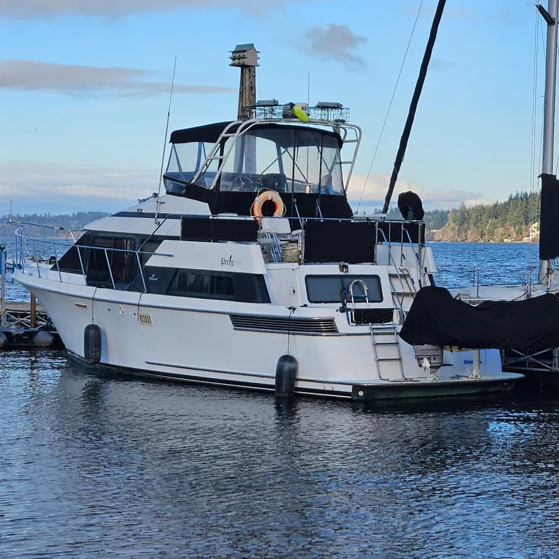 Slide: The Image of 1991 Tollycraft Euro Sport Sedan yacht docked on a serene lake. - 1
