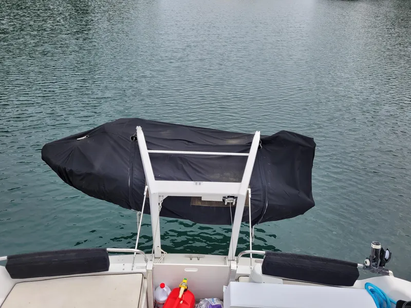 Slide: The Image of 1991 Tollycraft Euro Sport Sedan with covered equipment on calm water. - 12