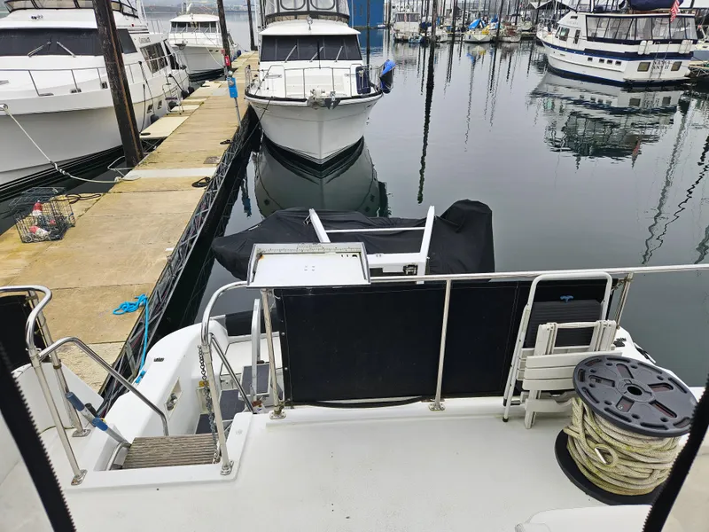 Slide: The Image of 1991 Tollycraft Euro Sport Sedan docked at marina with other boats. - 13