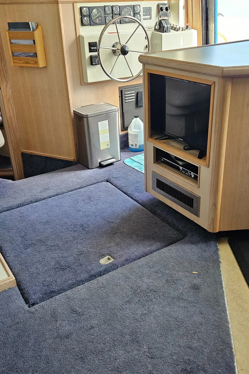 Slide: The Image of 1991 Tollycraft Euro Sport Sedan interior with steering wheel and entertainment center. - 26