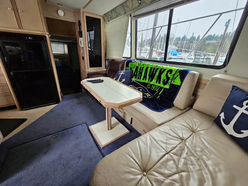 Slide: The Image of Interior of 1991 Tollycraft Euro Sport Sedan with cozy seating and nautical decor. - 28