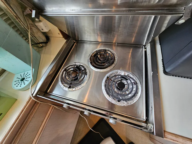 Slide: The Image of Stainless steel stove with three burners in a 1991 Tollycraft Euro Sport Sedan. - 33