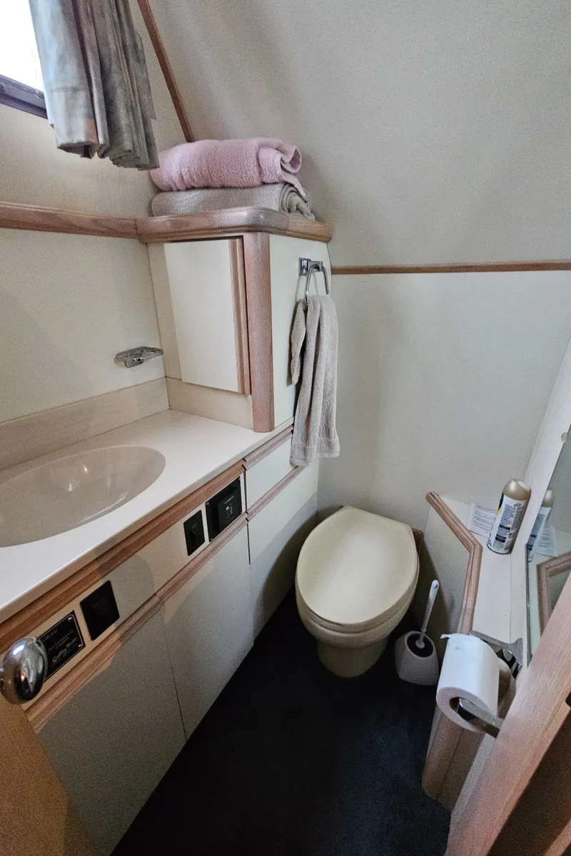 Slide: The Image of 1991 Tollycraft Euro Sport Sedan bathroom with sink, toilet, and storage. - 40