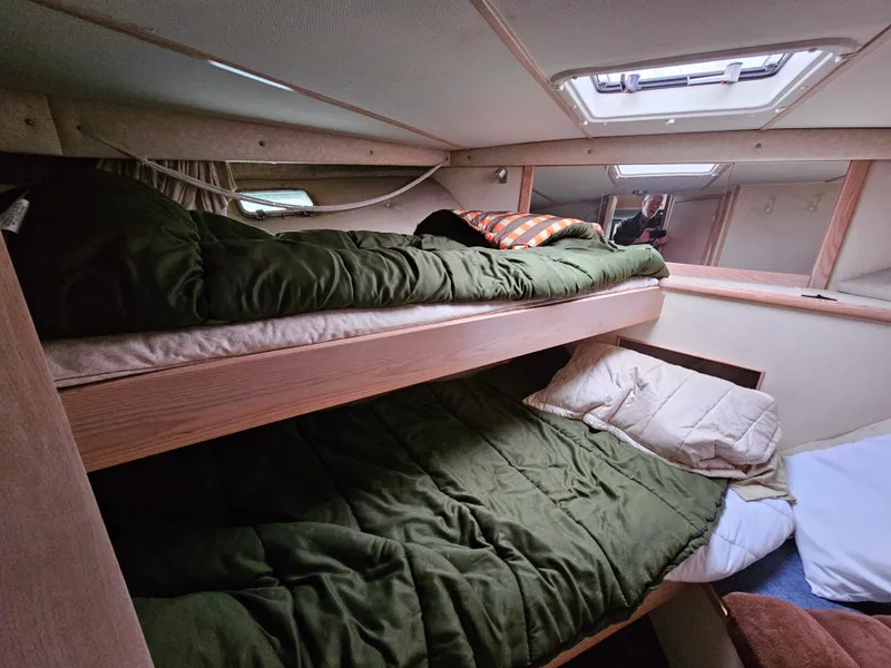 Slide: The Image of 1991 Tollycraft Euro Sport Sedan cabin with bunk beds and green bedding. - 43