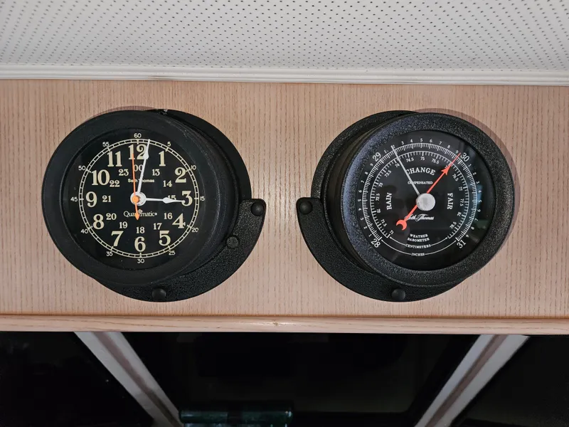 Slide: The Image of Analog clock and barometer on 1991 Tollycraft Euro Sport Sedan boat interior. - 51