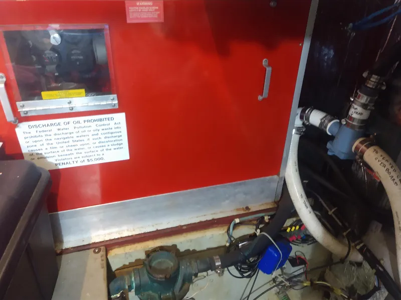 Slide: The Image of Engine room of 1991 Tollycraft Euro Sport Sedan with red panel and piping system. - 56