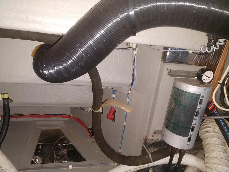 Slide: The Image of Engine room of 1991 Tollycraft Euro Sport Sedan with hoses and equipment. - 57