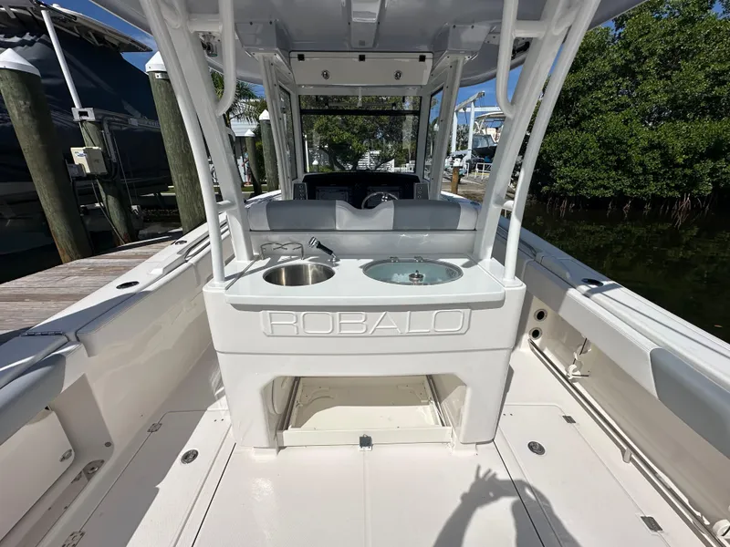 Slide: The Image of 2021 Robalo R302 Center Console boat interior with sink and storage. - 10