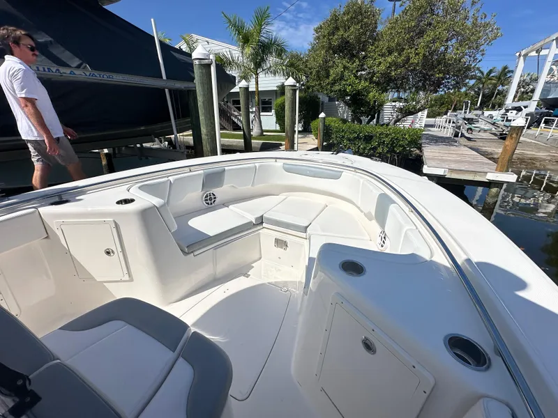 Slide: The Image of 2021 Robalo R302 Center Console boat docked, featuring spacious seating and sleek design. - 11