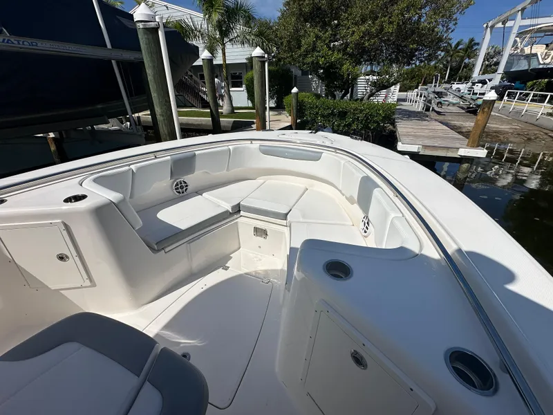 Slide: The Image of 2021 Robalo R302 Center Console boat with spacious seating and sleek design. - 12