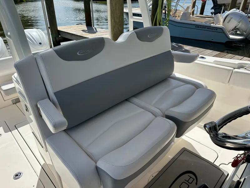 Slide: The Image of 2021 Robalo R302 Center Console boat seating, docked by the water. - 15