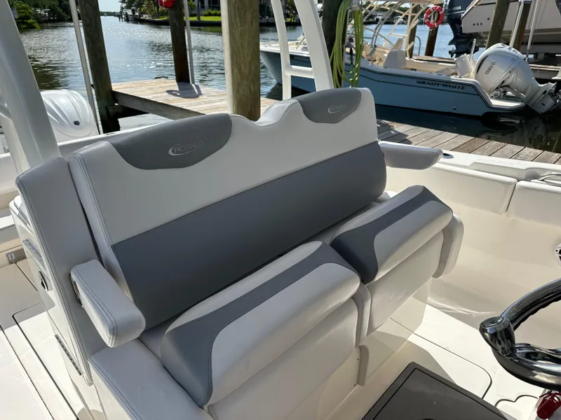 Slide: The Image of 2021 Robalo R302 Center Console boat seating by the dock. - 16