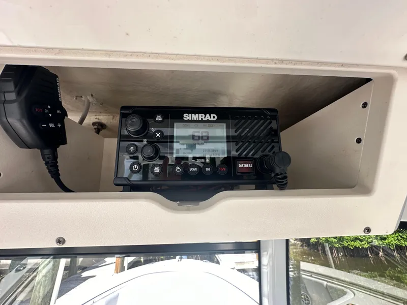 Slide: The Image of Simrad marine radio on 2021 Robalo R302 Center Console boat dashboard. - 19