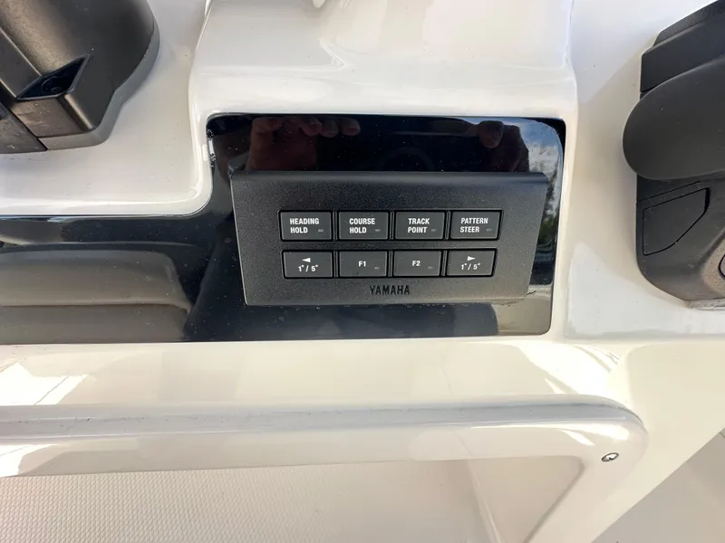 Slide: The Image of Control panel of a 2021 Robalo R302 Center Console boat with Yamaha features. - 24