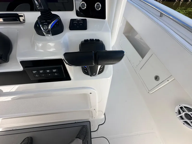 Slide: The Image of 2021 Robalo R302 Center Console boat controls and dashboard. - 25