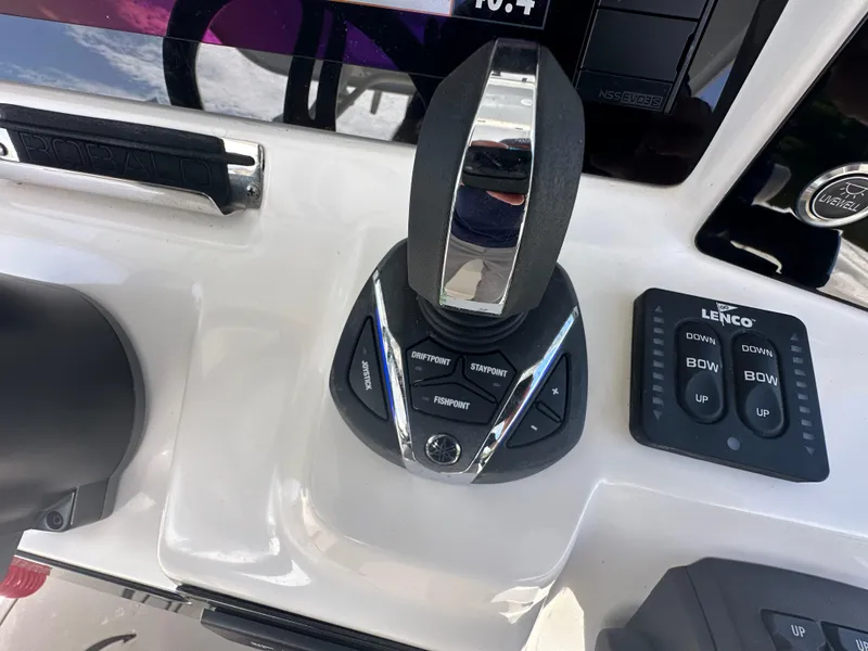 Slide: The Image of Close-up of 2021 Robalo R302 Center Console boat controls and joystick. - 29