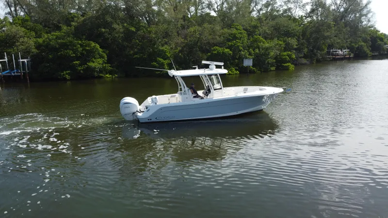 Slide: The Image of 2021 Robalo R302 Center Console boat cruising on a calm river. - 3