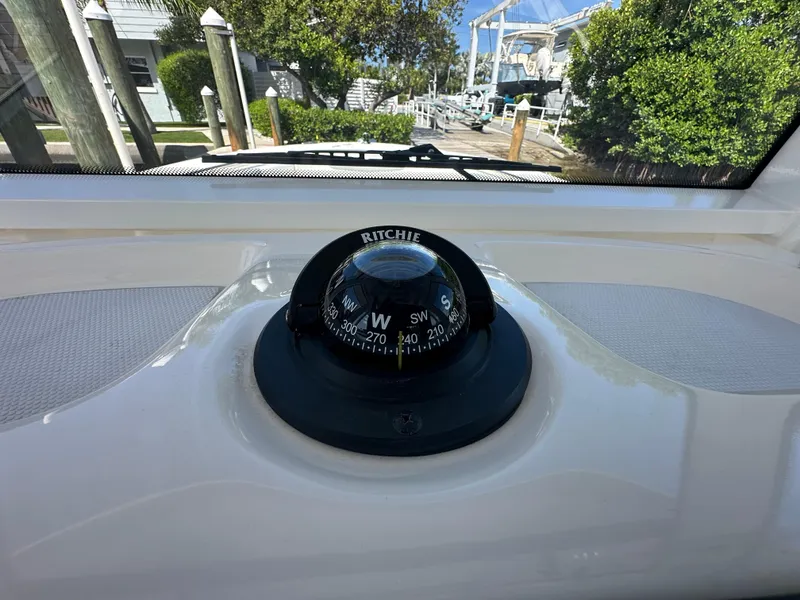 Slide: The Image of Ritchie compass on 2021 Robalo R302 Center Console boat dashboard. - 32