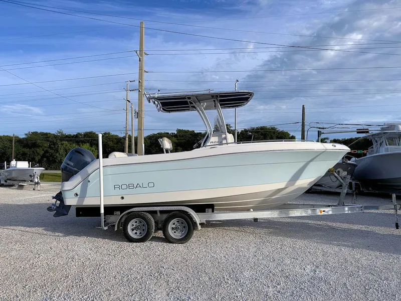 Slide: The Image of 2016 Robalo R222 Center Console boat on trailer under blue sky. - 1