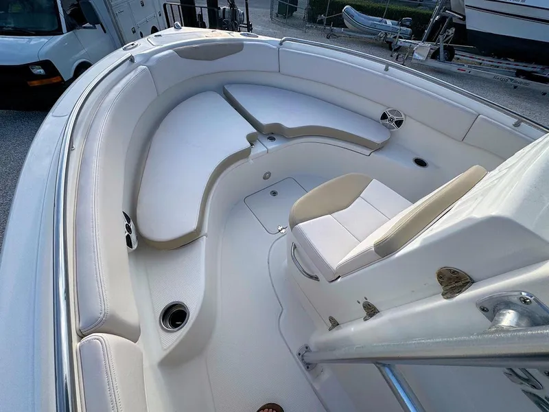 Slide: The Image of 2016 Robalo R222 Center Console boat interior with white seating and storage compartments. - 11