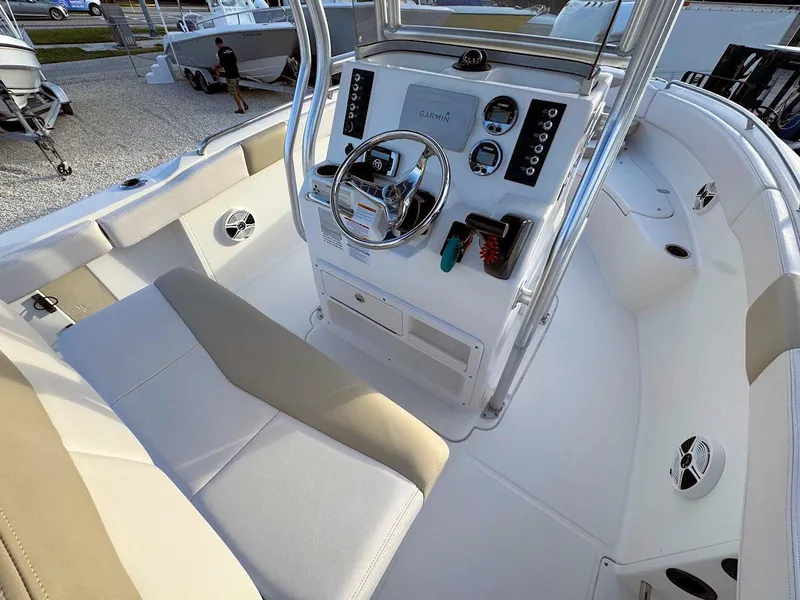Slide: The Image of 2016 Robalo R222 Center Console boat interior with steering wheel and controls. - 8