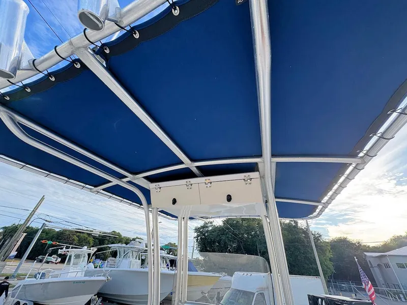 Slide: The Image of 2016 Robalo R222 Center Console boat with blue T-top canopy. - 9