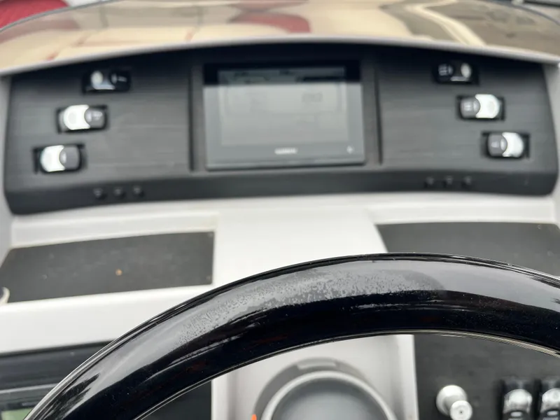 Slide: The Image of Dashboard of 2024 Bennington 25LTFB boat with control panel and steering wheel. - 10