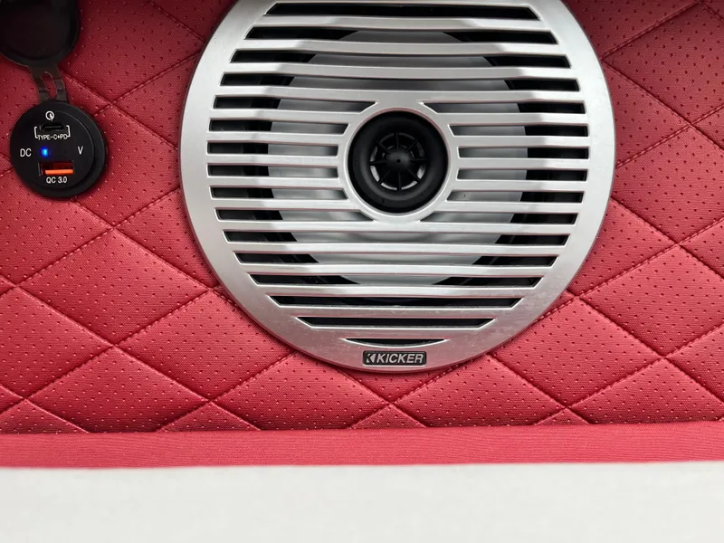 Slide: The Image of 2024 Bennington 25LTFB boat speaker with red quilted panel and voltage gauge. - 13