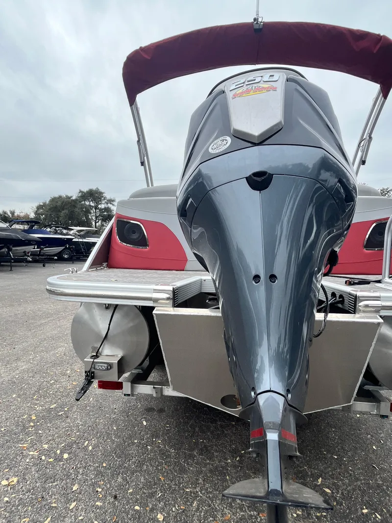 Slide: The Image of 2024 Bennington 25LTFB pontoon boat with powerful outboard motor. - 17