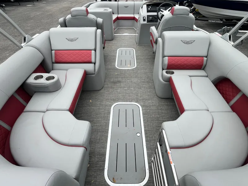Slide: The Image of 2024 Bennington 25LTFB pontoon boat with luxurious gray and red seating. - 3