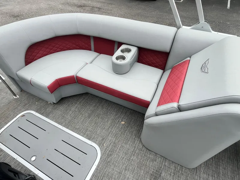 Slide: The Image of 2024 Bennington 25LTFB boat seating with red and gray upholstery, featuring cup holders. - 8