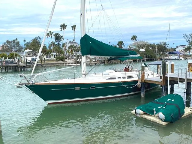 The Image of Green Freedom 45 sailboat docked in a marina, 1992 model, with palm trees in the background. - 0