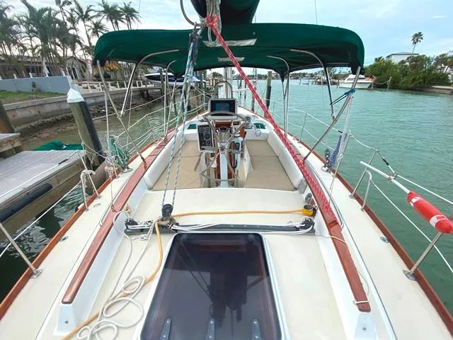 Slide: The Image of Sailboat Freedom 45, 1992 model, docked in a marina with lush surroundings. - 13