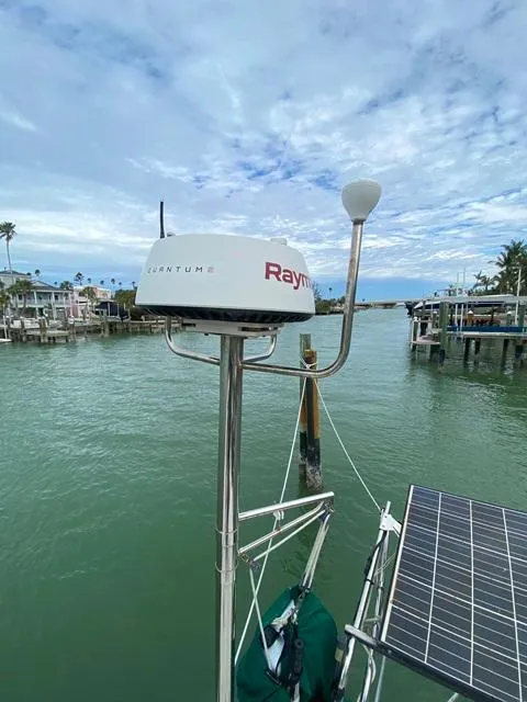 Slide: The Image of Marine radar and solar panel on a Freedom 45 boat, 1992, docked by a calm waterfront. - 16