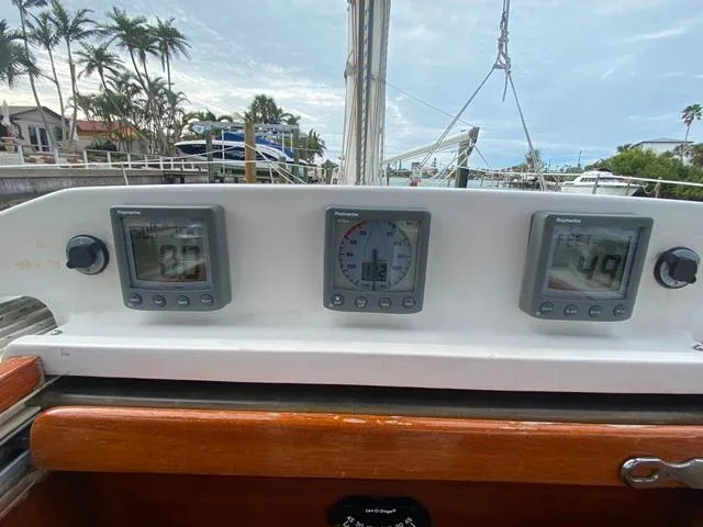 Slide: The Image of Sailboat cockpit with navigation instruments, Freedom 45, 1992 model, docked near palm trees. - 20