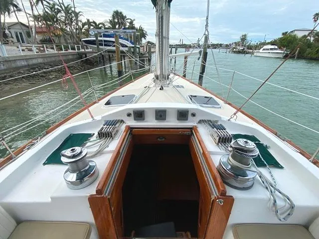Slide: The Image of Sailboat deck view, Freedom 45 model, 1992, docked in a marina with palm trees. - 23