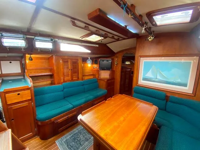 Slide: The Image of Luxurious 1992 Freedom 45 yacht interior with wooden furnishings and teal seating. - 25