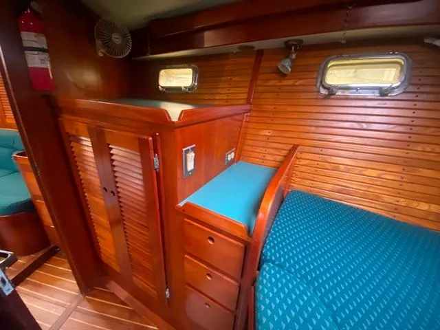 Slide: The Image of Cozy cabin interior of 1992 Freedom 45 yacht with wooden paneling and teal upholstery. - 35