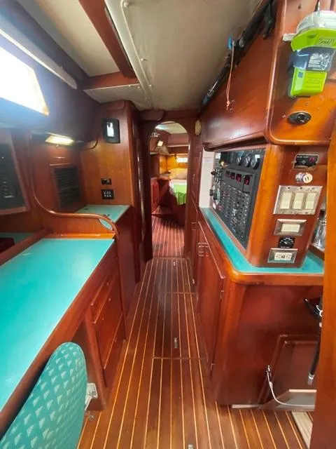 Slide: The Image of Interior of a 1992 Freedom 45 sailboat with wooden flooring and teal countertops. - 40