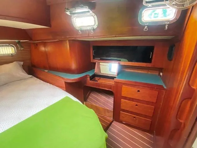 Slide: The Image of Cozy cabin interior of 1992 Freedom 45 yacht with wooden furnishings and bed. - 45