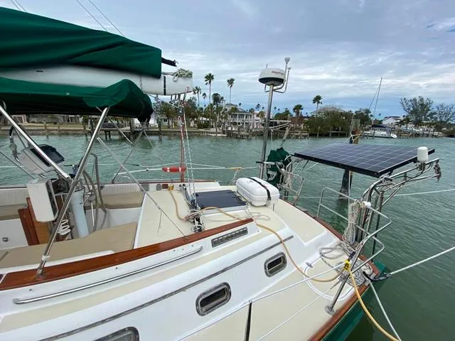 Slide: The Image of Sailboat Freedom 45, 1992 model, docked with solar panels and green canopy. - 5