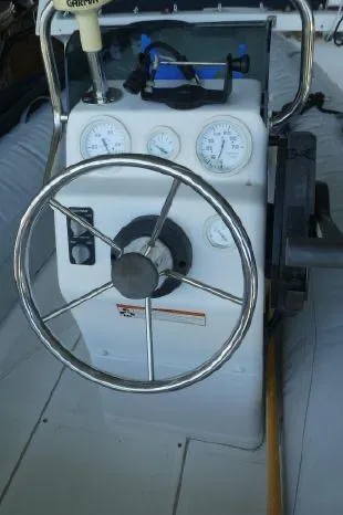 Slide: The Image of 1983 Ocean Alexander 43 boat helm with steering wheel and gauges. - 11
