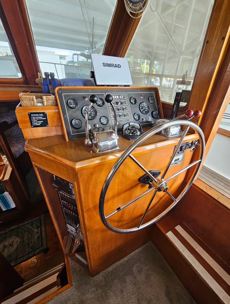 Slide: The Image of 1983 Ocean Alexander 43 helm with classic wooden dashboard and steering wheel. - 13