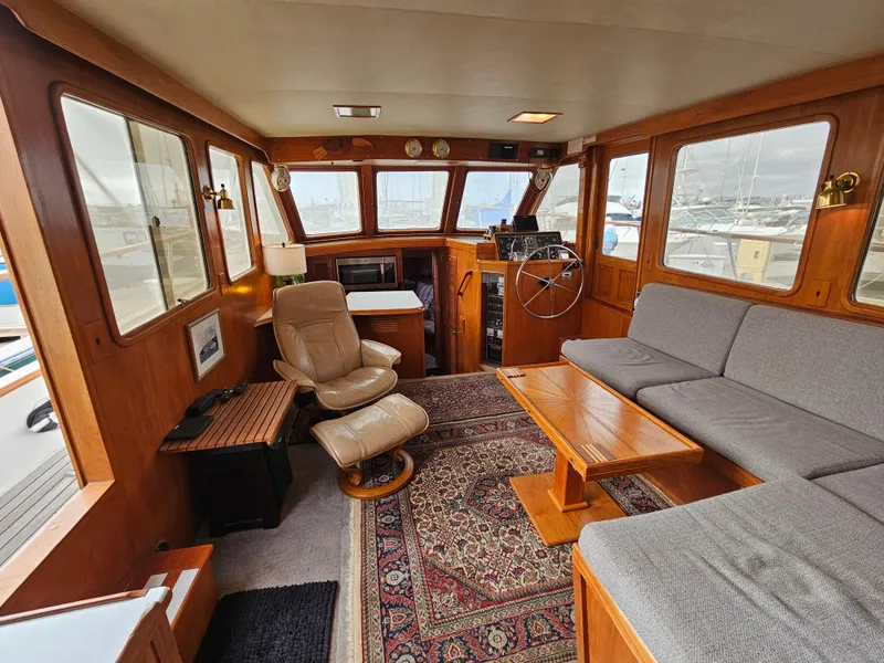 Slide: The Image of Interior of 1983 Ocean Alexander 43 yacht with cozy seating and helm station. - 15