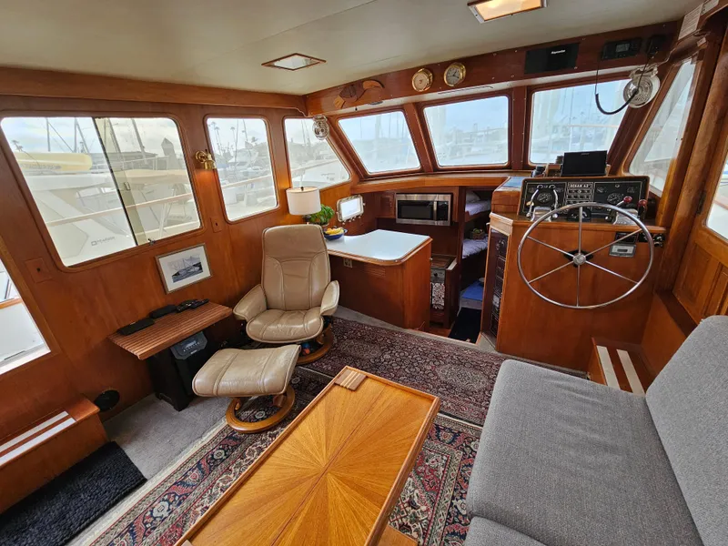 Slide: The Image of Interior of 1983 Ocean Alexander 43 yacht with wooden decor and comfortable seating. - 16