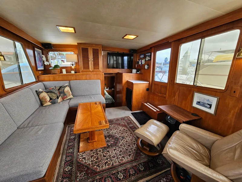 Slide: The Image of Interior of 1983 Ocean Alexander 43 yacht with cozy seating and wooden accents. - 17
