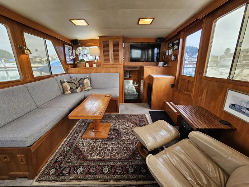 Slide: The Image of Interior of 1983 Ocean Alexander 43 yacht with cozy seating and elegant wood finishes. - 19